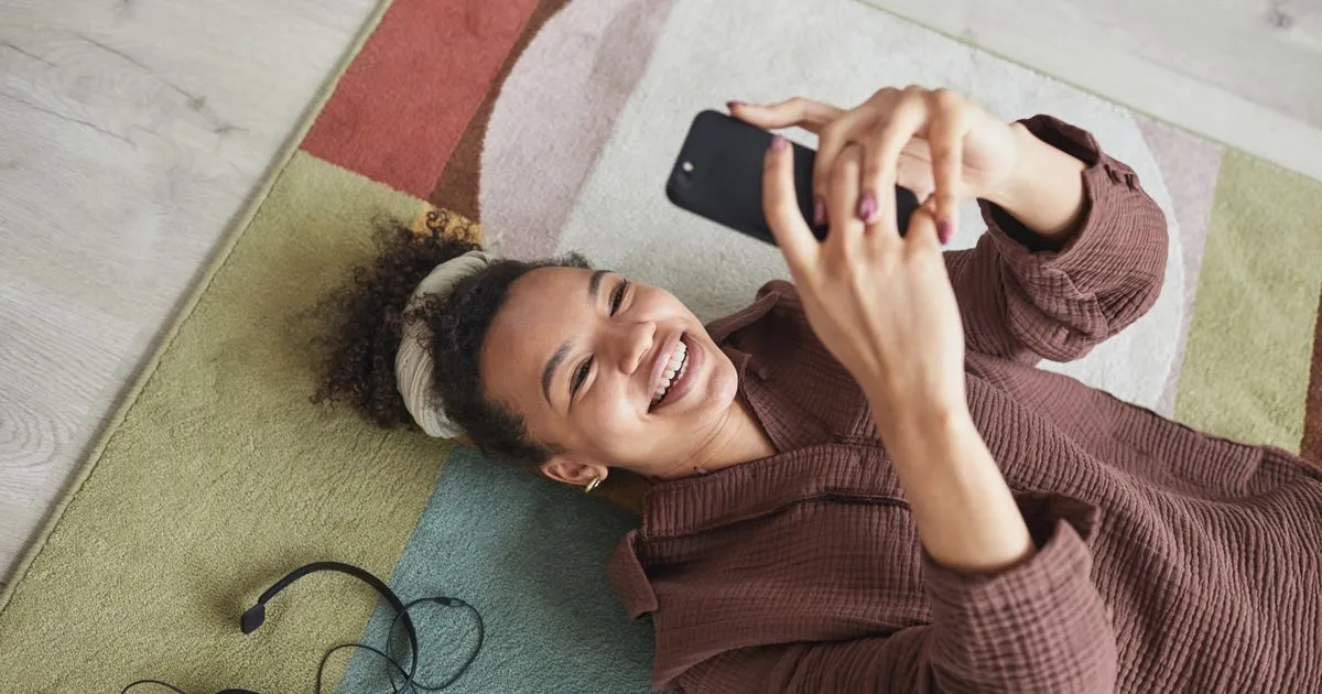 Smiling woman applying for a quick $500 loan on her phone