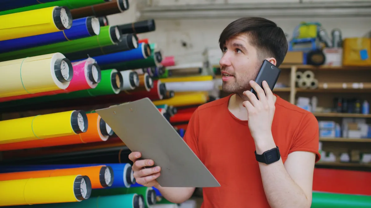 Part-time warehouse worker on the phone with a lender about his bad credit quick loans application