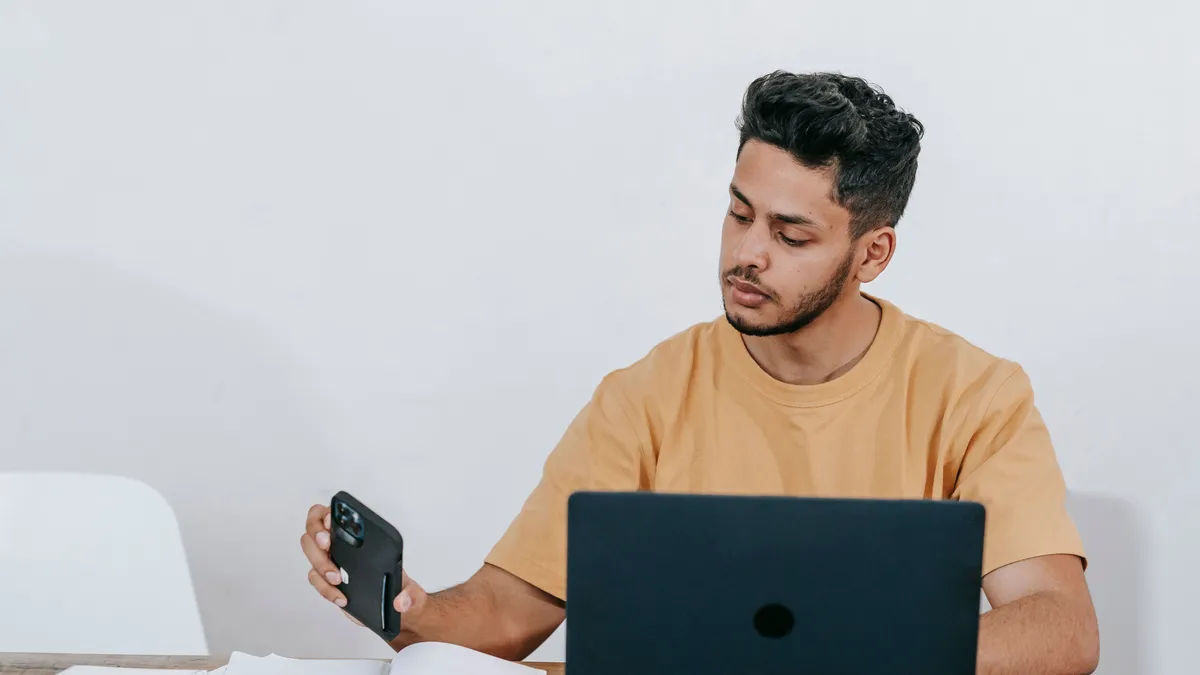Man checking his pay deposits on his phone before a $500 loan income check