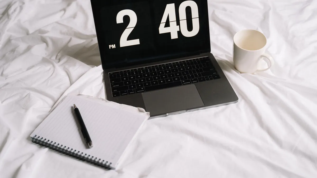 Laptop showing 2:40 pm beside a coffee and notebook: an afternoon signature on quick cash loans usually lands the next business morning